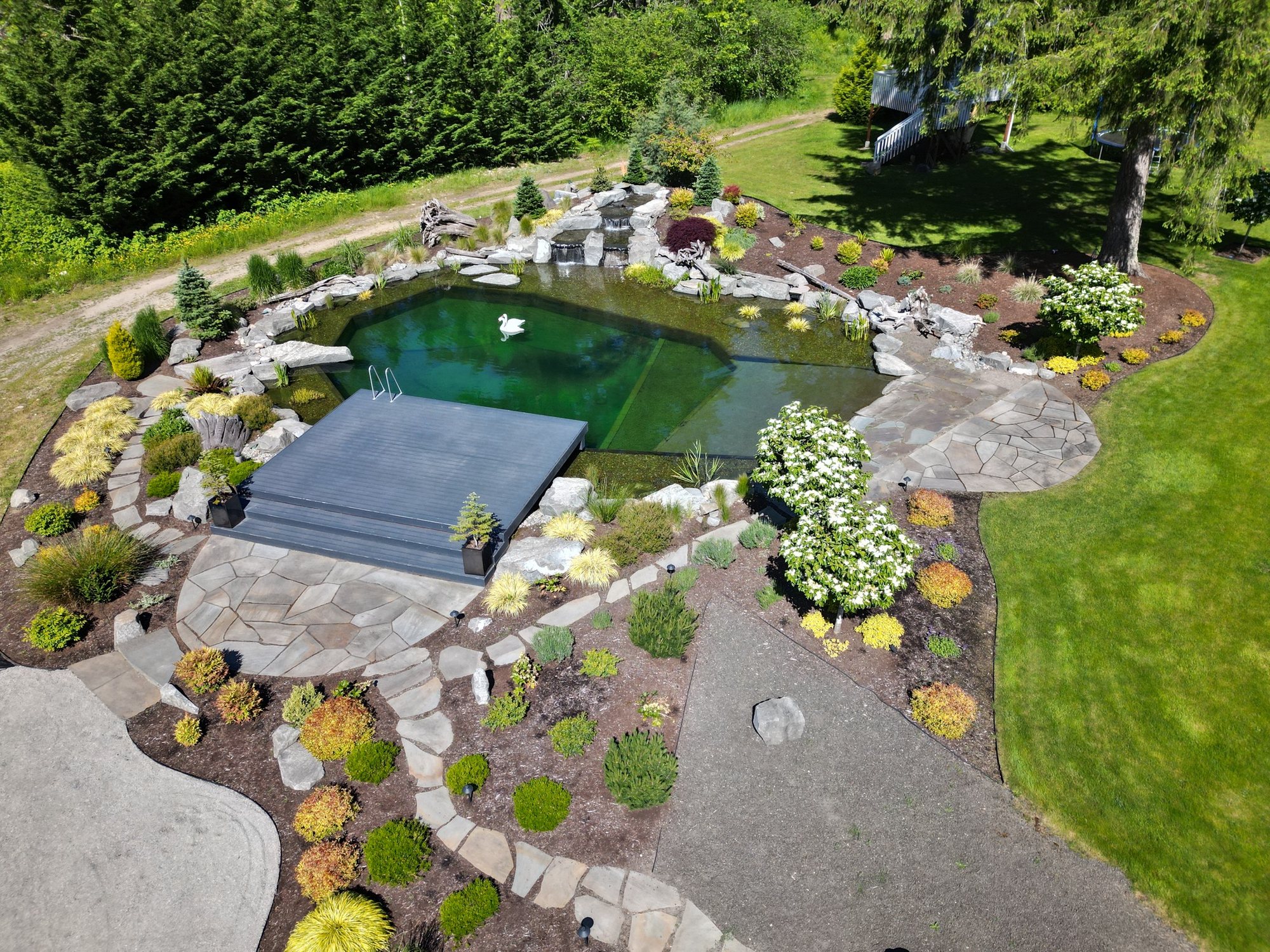 Aerial view of a complete garden layout with pathways, stonework, planting, and lawn
