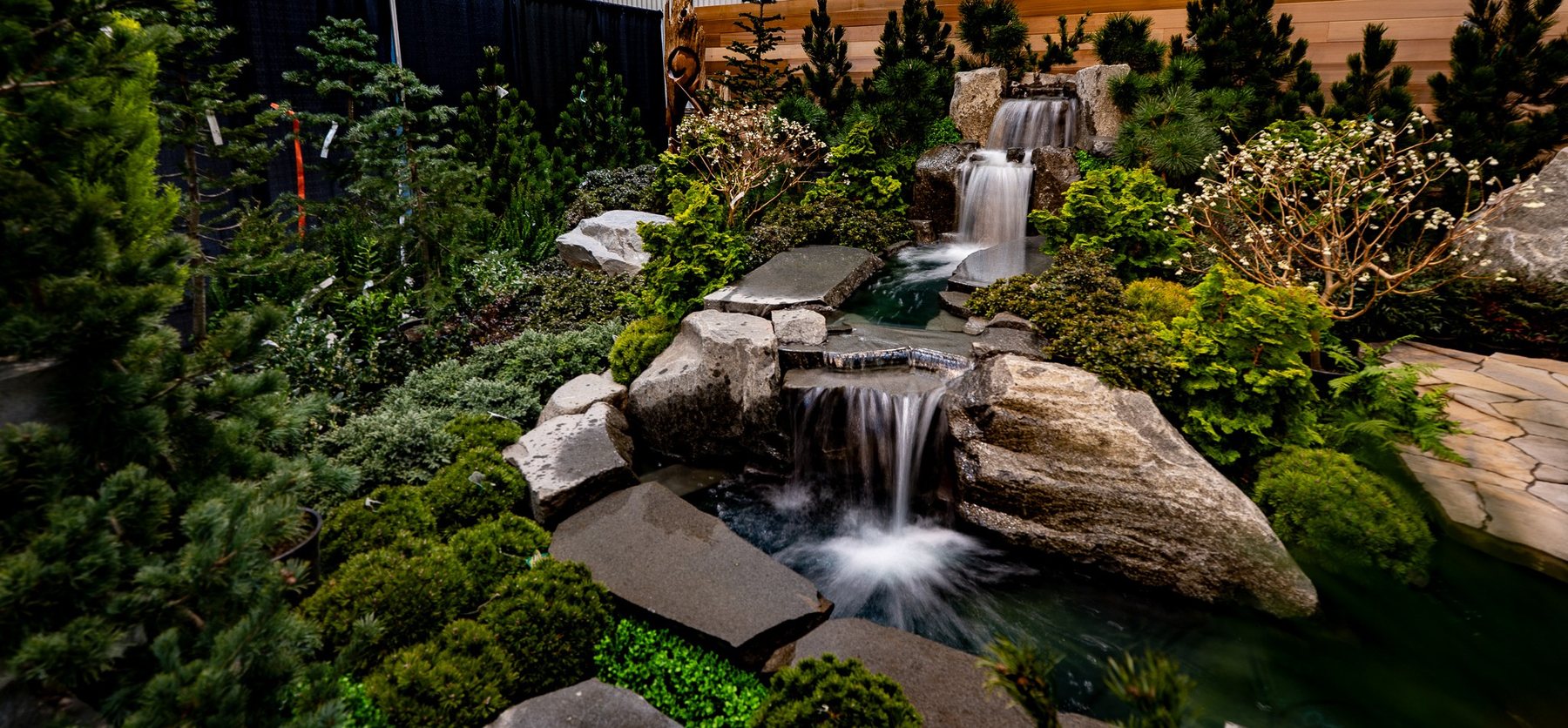 Layered stone waterfall surrounded by planting